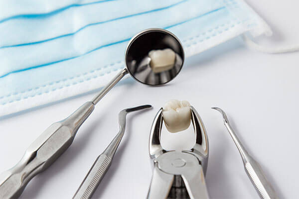 dental tools with extracted tooth