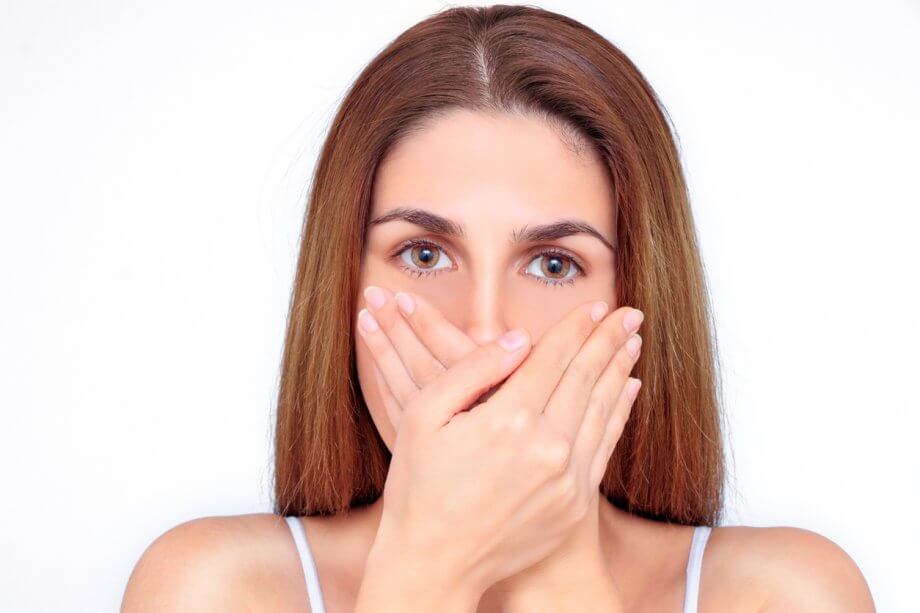 Woman Covering Mouth Due To Bad Breath