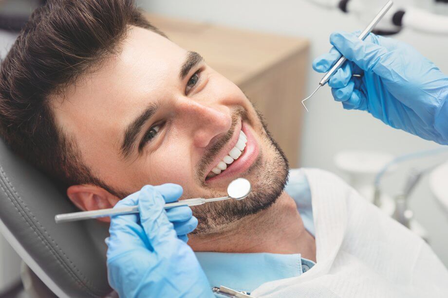 man in dental chair smiling