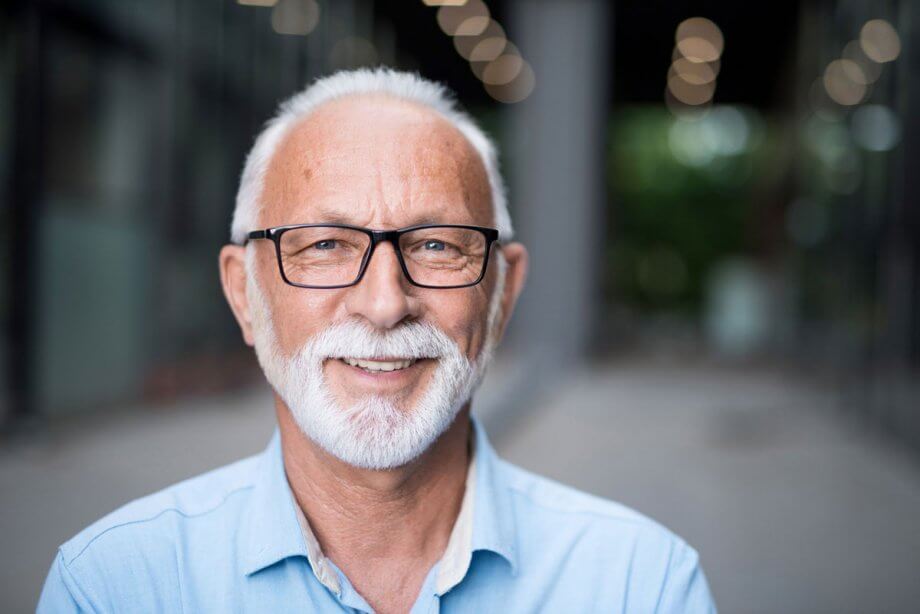 older man with beard and black-rimmed glasses