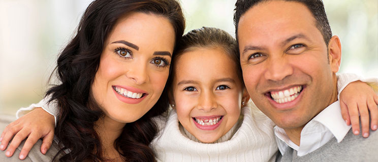 Mom, Dad and daughter smiling