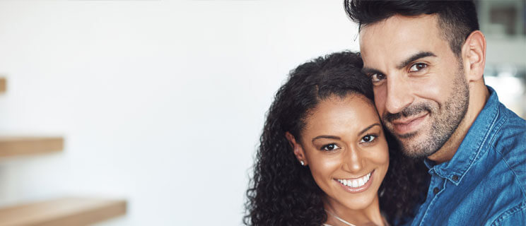 young couple hugging and smiling