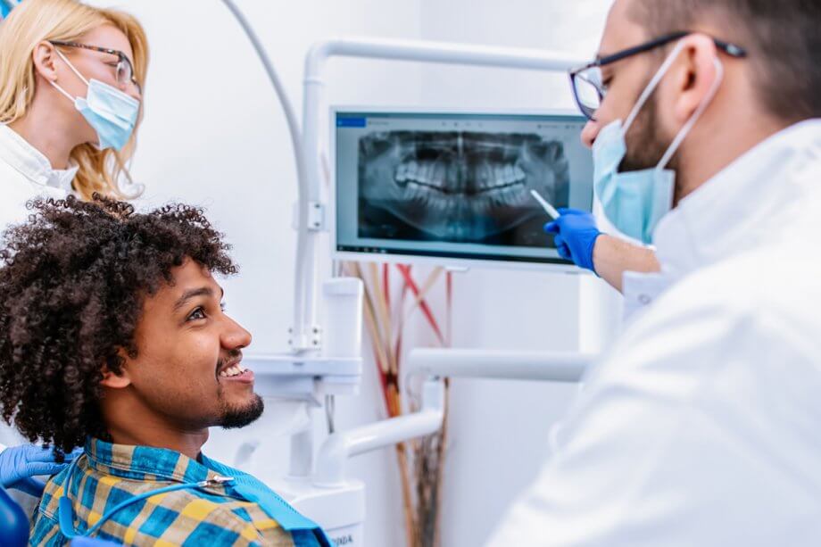 man speaking with dental professionals