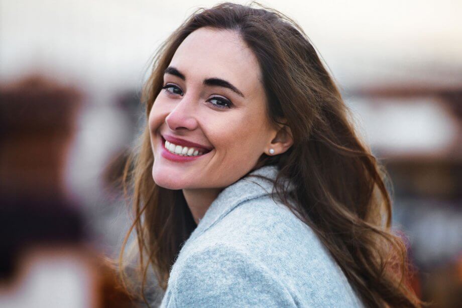 young smiling woman looking over shoulder